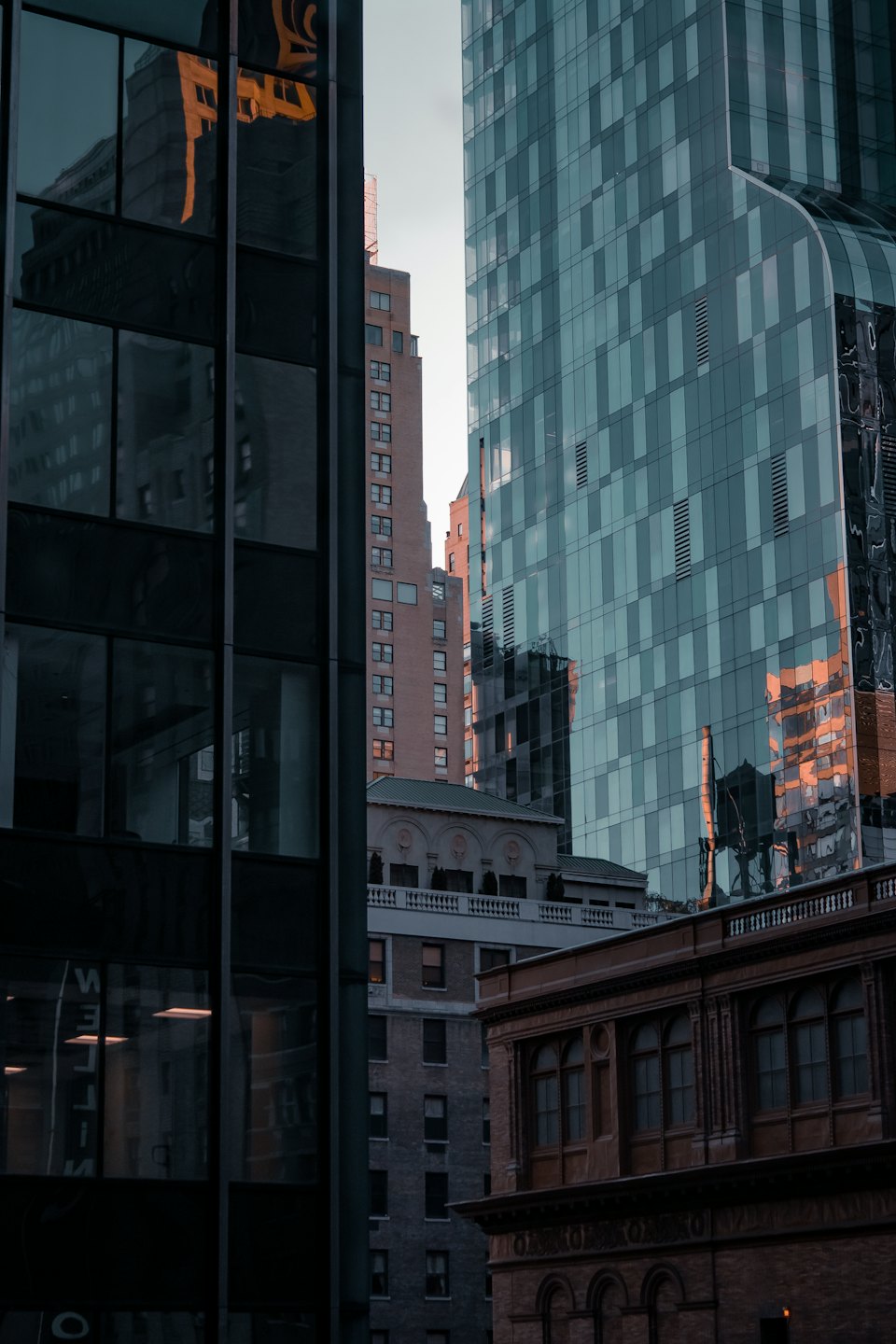 Modern skyscrapers and historic buildings stand together in a city.