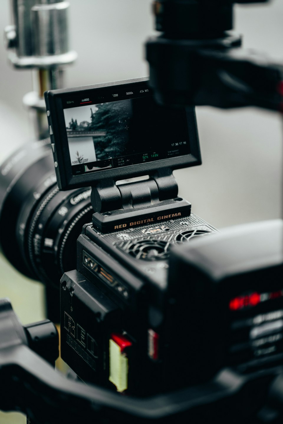 Professional video camera mounted on a rig displaying technical data.